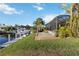 Beautiful backyard with lush landscaping, leading to a private boat dock, and canal views at 1111 Socorro Dr, Punta Gorda, FL 33950