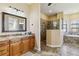 Elegant bathroom with granite vanity, soaking tub, and walk-in shower at 1111 Socorro Dr, Punta Gorda, FL 33950