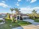 Beautiful waterfront home with a three car garage, tile roof, and lush tropical landscaping at 1111 Socorro Dr, Punta Gorda, FL 33950