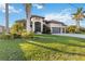 Stunning home with a three car garage, tile roof, and beautiful tropical landscaping at 1111 Socorro Dr, Punta Gorda, FL 33950