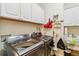 Laundry room features sink, washer, dryer, and white cabinets at 1111 Socorro Dr, Punta Gorda, FL 33950