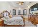 Main bedroom with a king-size bed, dresser, and large TV at 1111 Socorro Dr, Punta Gorda, FL 33950