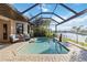 Inviting backyard pool with screened-in lanai, perfect for relaxation and enjoying the waterfront at 1111 Socorro Dr, Punta Gorda, FL 33950