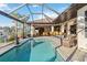 Sparkling pool in a screened enclosure with outdoor seating, bar, and lovely waterfront views at 1111 Socorro Dr, Punta Gorda, FL 33950