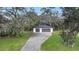 Two-car detached garage with dark gray doors and a light-colored exterior at 15125 Waterline Rd, Bradenton, FL 34212