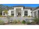 Front entrance of a modern white house with stone pillars and landscaping at 15125 Waterline Rd, Bradenton, FL 34212