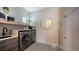 Modern laundry room with washer, dryer, and stylish cabinetry at 15125 Waterline Rd, Bradenton, FL 34212