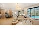 Open living room with large sectional sofa, fireplace, and pool view at 15125 Waterline Rd, Bradenton, FL 34212