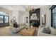 Spacious living room with a modern fireplace, light beige sofas, and large windows at 15125 Waterline Rd, Bradenton, FL 34212