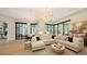 Spacious living area with sectional sofa, large windows, and pool access at 15125 Waterline Rd, Bradenton, FL 34212