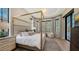 Luxurious main bedroom with canopy bed and large windows overlooking backyard at 15125 Waterline Rd, Bradenton, FL 34212