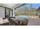 Relaxing screened-in pool and patio area with comfortable wicker furniture at 15125 Waterline Rd, Bradenton, FL 34212