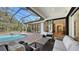 Relaxing covered patio with pool and spa, outdoor kitchen, and seating area at 15125 Waterline Rd, Bradenton, FL 34212