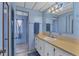 Bathroom with light blue vanity and tiled shower at 1523 46Th E Ave, Ellenton, FL 34222