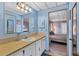 Bathroom with light blue vanity and view of bedroom at 1523 46Th E Ave, Ellenton, FL 34222