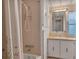 Bathroom with floral shower curtain and vanity at 1523 46Th E Ave, Ellenton, FL 34222