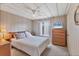 Bedroom with floral bedding and ceiling fan at 1523 46Th E Ave, Ellenton, FL 34222