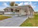 White mobile home with carport and landscaped yard at 1523 46Th E Ave, Ellenton, FL 34222
