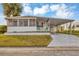 Single-wide manufactured home with carport and covered porch at 1523 46Th E Ave, Ellenton, FL 34222