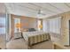 Main bedroom with striped bedding and ceiling fan at 1523 46Th E Ave, Ellenton, FL 34222