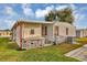 Rear view of mobile home with stonework and AC unit at 1523 46Th E Ave, Ellenton, FL 34222