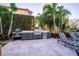 Outdoor kitchen with grill and ample counter space at 1541 Bay Point Dr, Sarasota, FL 34236