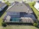Aerial view of a home with a solar panel and screened pool and spa at 17539 Polo Trl, Bradenton, FL 34211