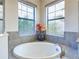 Relax in this spa-like bathroom, featuring a large soaking tub and modern fixtures at 17539 Polo Trl, Bradenton, FL 34211
