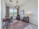Spacious home office with a large desk, comfortable chair, and natural light at 17539 Polo Trl, Bradenton, FL 34211