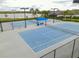 Two well-maintained tennis courts with seating area at 17539 Polo Trl, Bradenton, FL 34211