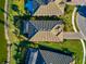 Aerial view of homes with tile roofs, landscaping, and a lake at 20861 Cattail Blvd, Venice, FL 34292