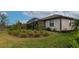 Landscaped backyard with a screened patio at 20861 Cattail Blvd, Venice, FL 34292