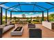 Relaxing outdoor space with covered patio, fire pit, and lake view at 20861 Cattail Blvd, Venice, FL 34292