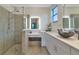 Elegant bathroom with double sinks, a large shower, and modern white cabinets at 20861 Cattail Blvd, Venice, FL 34292