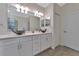 Spacious bathroom with double sinks, a large mirror, and white cabinets at 20861 Cattail Blvd, Venice, FL 34292