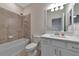 Clean bathroom with a shower/tub combo, white vanity, and a framed mirror at 20861 Cattail Blvd, Venice, FL 34292
