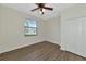 Bright bedroom featuring wood-look floors and a double door closet at 20861 Cattail Blvd, Venice, FL 34292