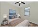 Bedroom with a queen-size bed, nightstands, and a ceiling fan at 20861 Cattail Blvd, Venice, FL 34292