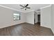 Comfortable bedroom with ceiling fan and wood-look flooring at 20861 Cattail Blvd, Venice, FL 34292