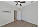 Bedroom with wood-look floors and access to a bathroom at 20861 Cattail Blvd, Venice, FL 34292