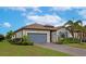 House exterior with gray garage door and landscaping at 20861 Cattail Blvd, Venice, FL 34292