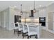 Modern kitchen with white cabinets, quartz counters, and island at 20861 Cattail Blvd, Venice, FL 34292