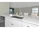 Modern kitchen with white cabinets, quartz countertops, and stainless steel appliances at 20861 Cattail Blvd, Venice, FL 34292