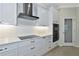 Modern kitchen with white cabinets, quartz counters, and island at 20861 Cattail Blvd, Venice, FL 34292