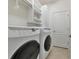Convenient laundry room with washer, dryer, and storage cabinets at 20861 Cattail Blvd, Venice, FL 34292