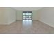 Bright living room with sliding doors leading to a patio and lake view at 20861 Cattail Blvd, Venice, FL 34292