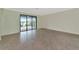 Spacious living area with sliding doors to a patio and lake view at 20861 Cattail Blvd, Venice, FL 34292