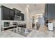 Modern kitchen with dark cabinetry, stainless steel appliances, and granite countertops at 2155 Jagust Rd, North Port, FL 34288