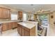 Modern kitchen with light wood cabinets, stainless steel appliances, and an island at 243 River Enclave Ct, Bradenton, FL 34212