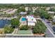 Community pool, shuffleboard courts, and waterway access from above at 2505 Riverbluff Pkwy # V196, Sarasota, FL 34231